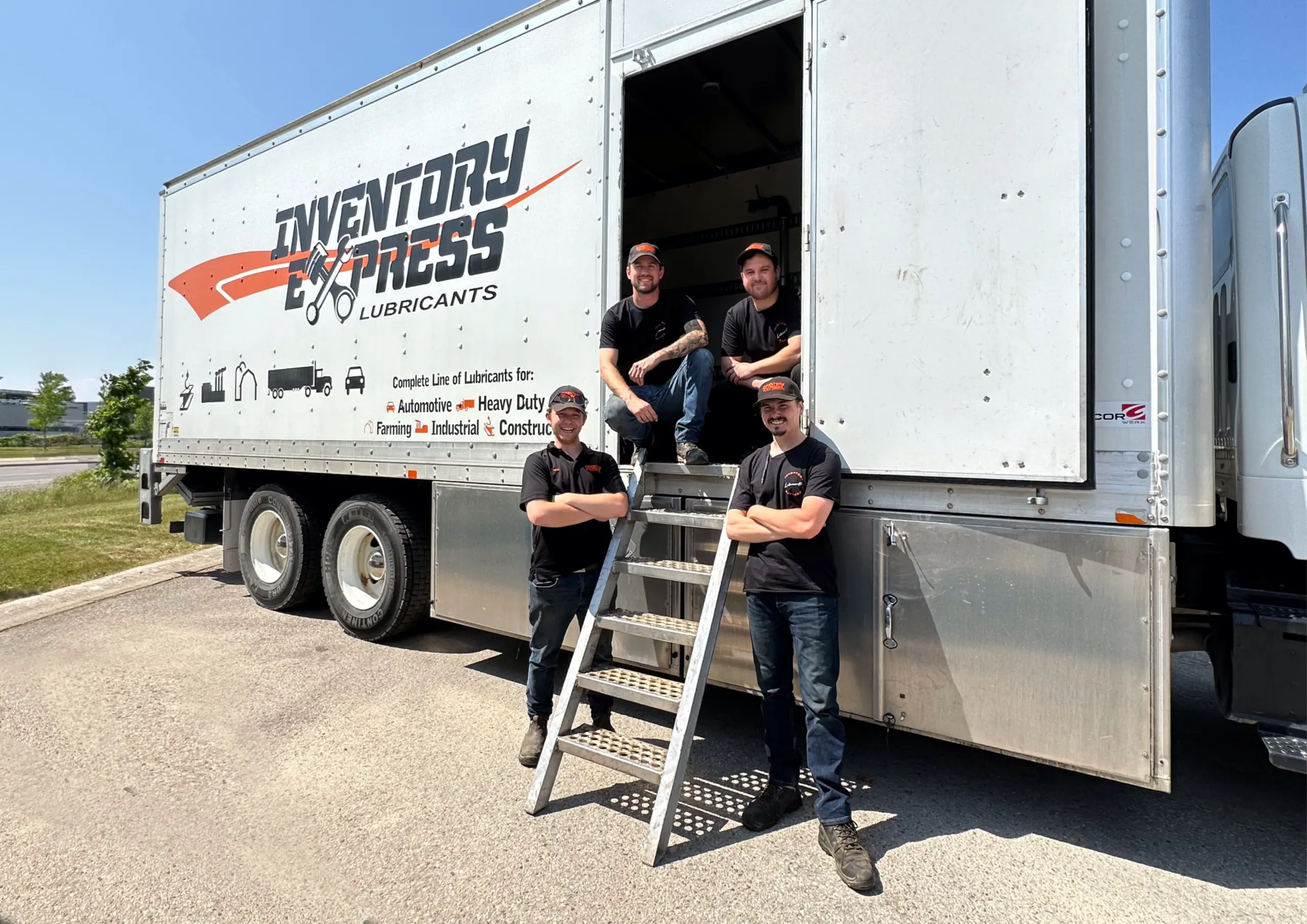 The Inventory Express team in front of a truck.