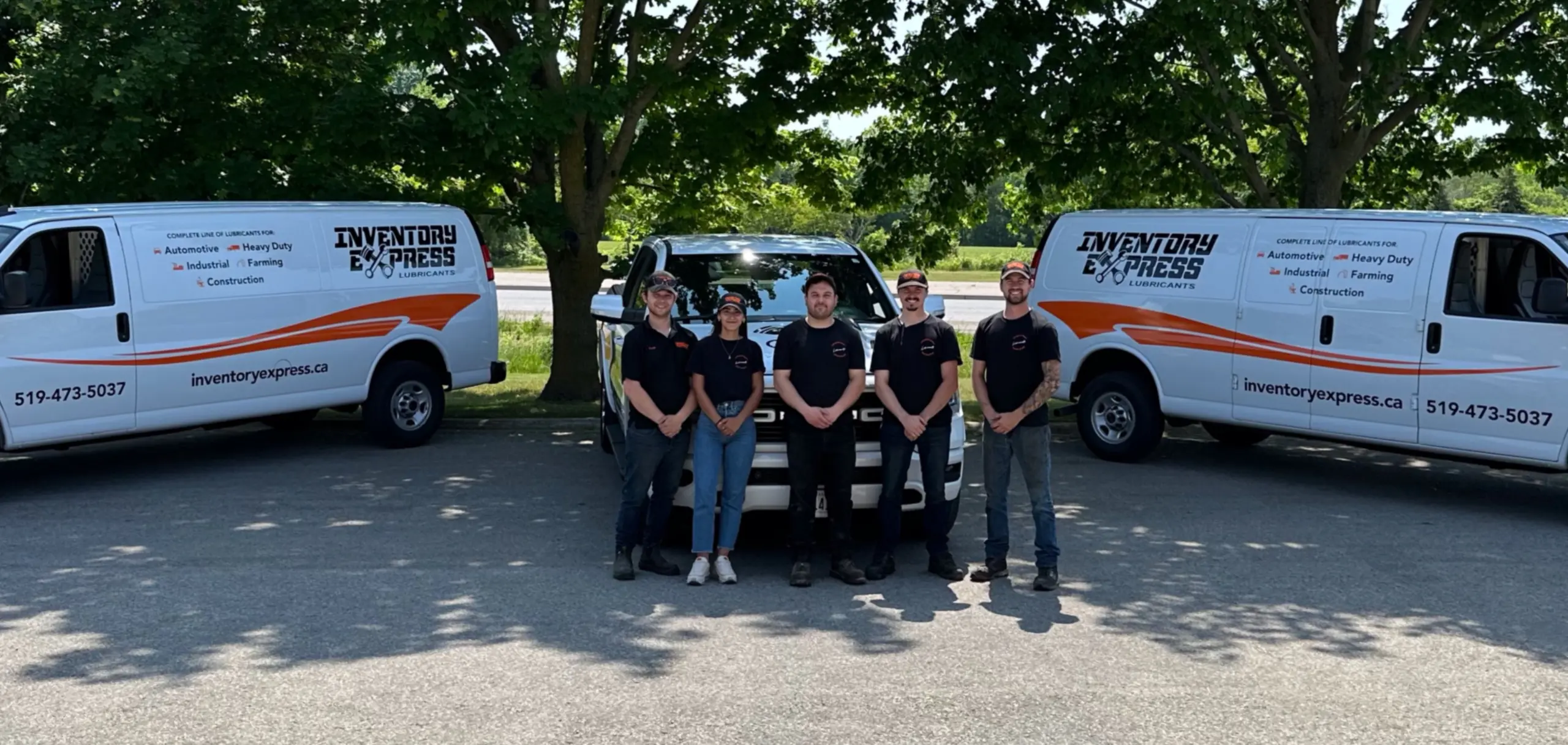 Inventory Express team in front of vehicles.