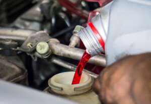 Transmission fuel being poured into a vehicle.