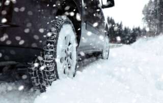 Checking engine oil in freezing Ontario winter conditions to ensure proper cold-weather protection